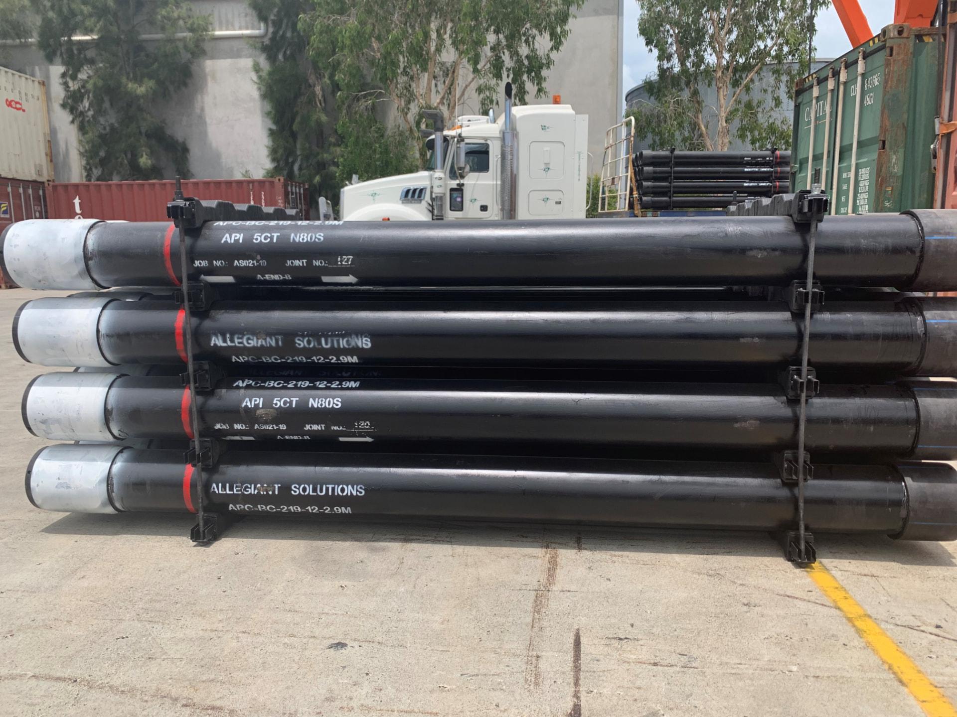 Marked Allegiant Solutions APC-BC casing joints strapped on a pallet ready for transport