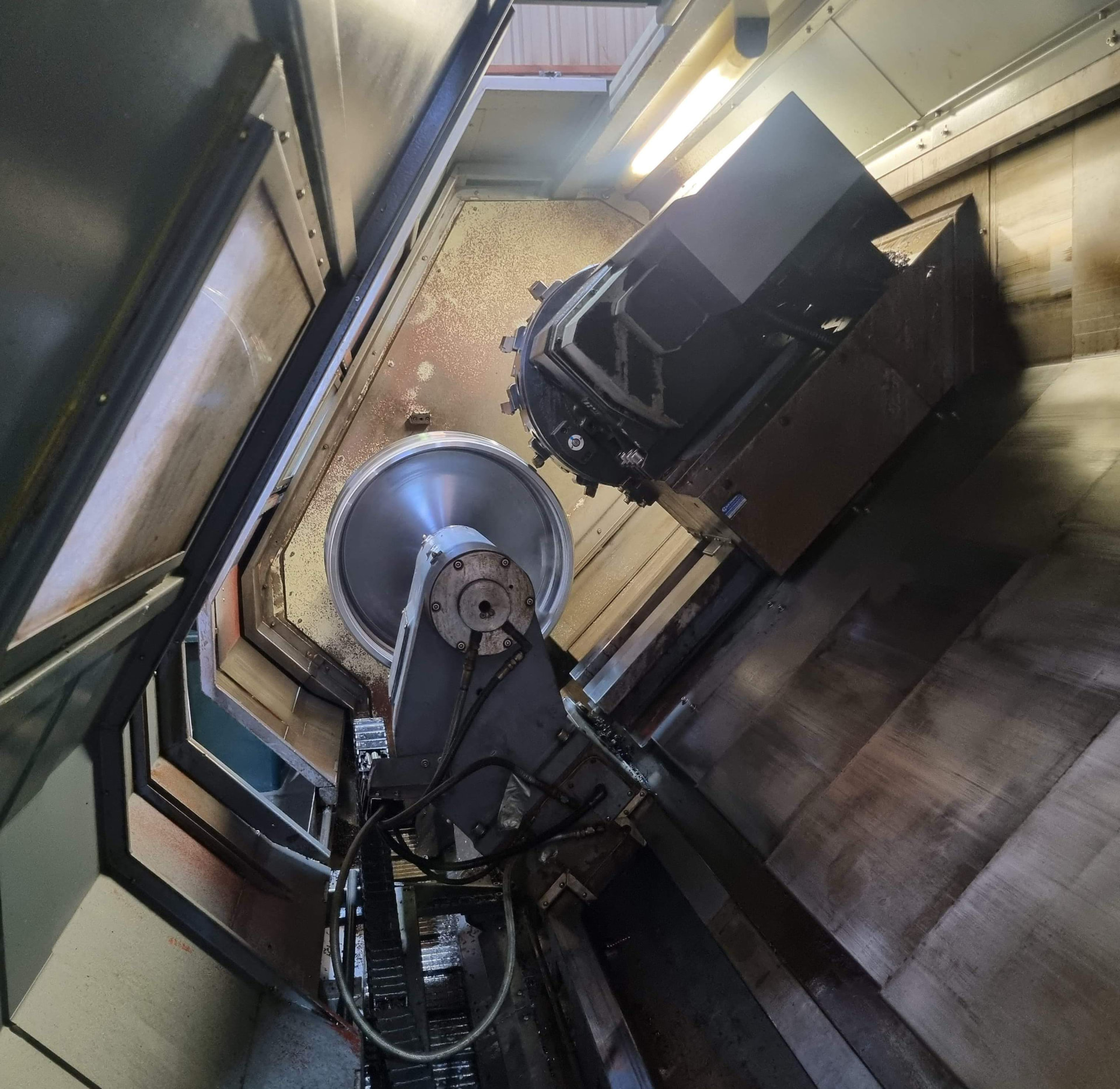 CNC machine turning a large steel casing component