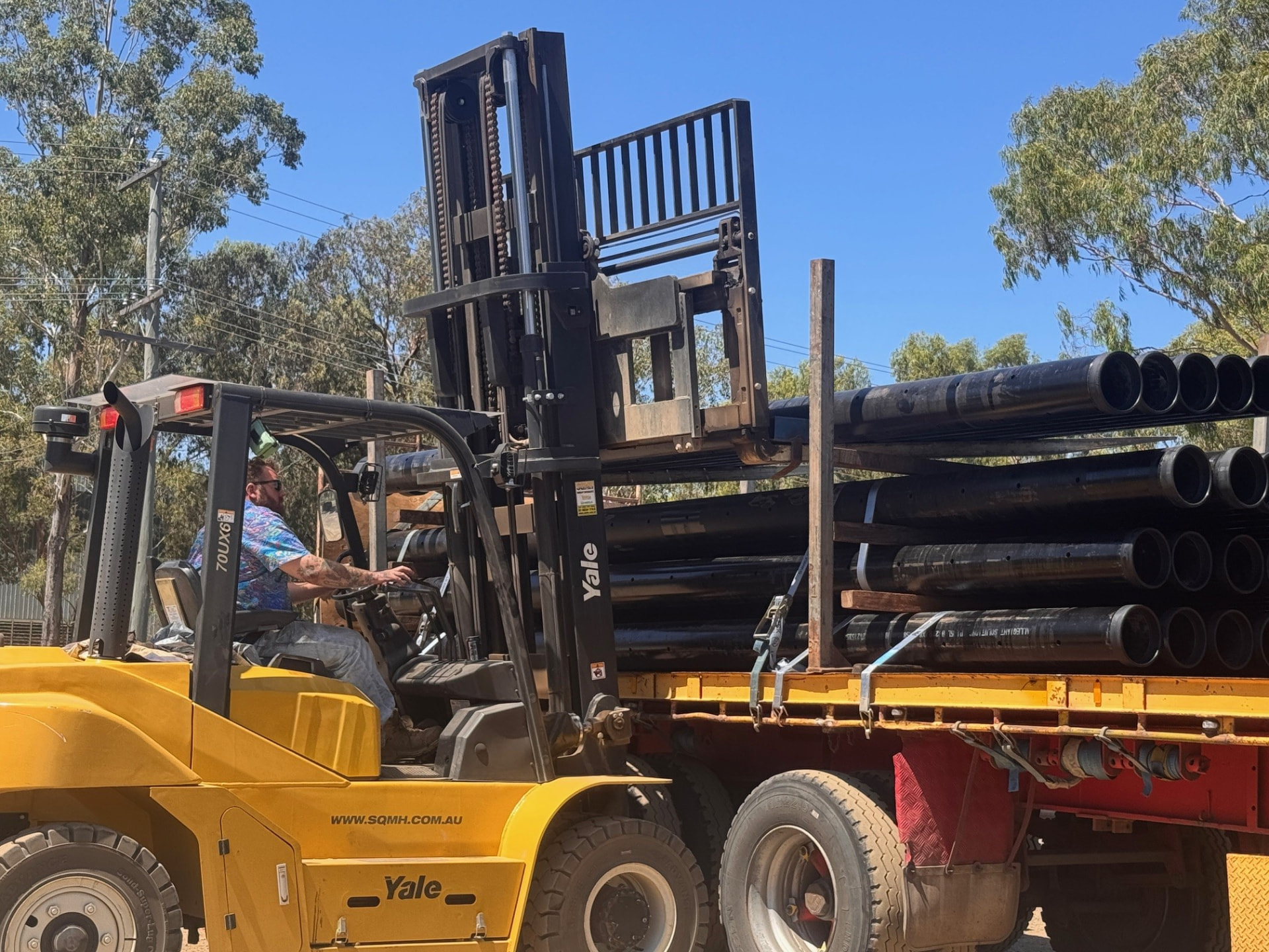 Forklift loading Allegiant casing pipe onto a truck for delivery