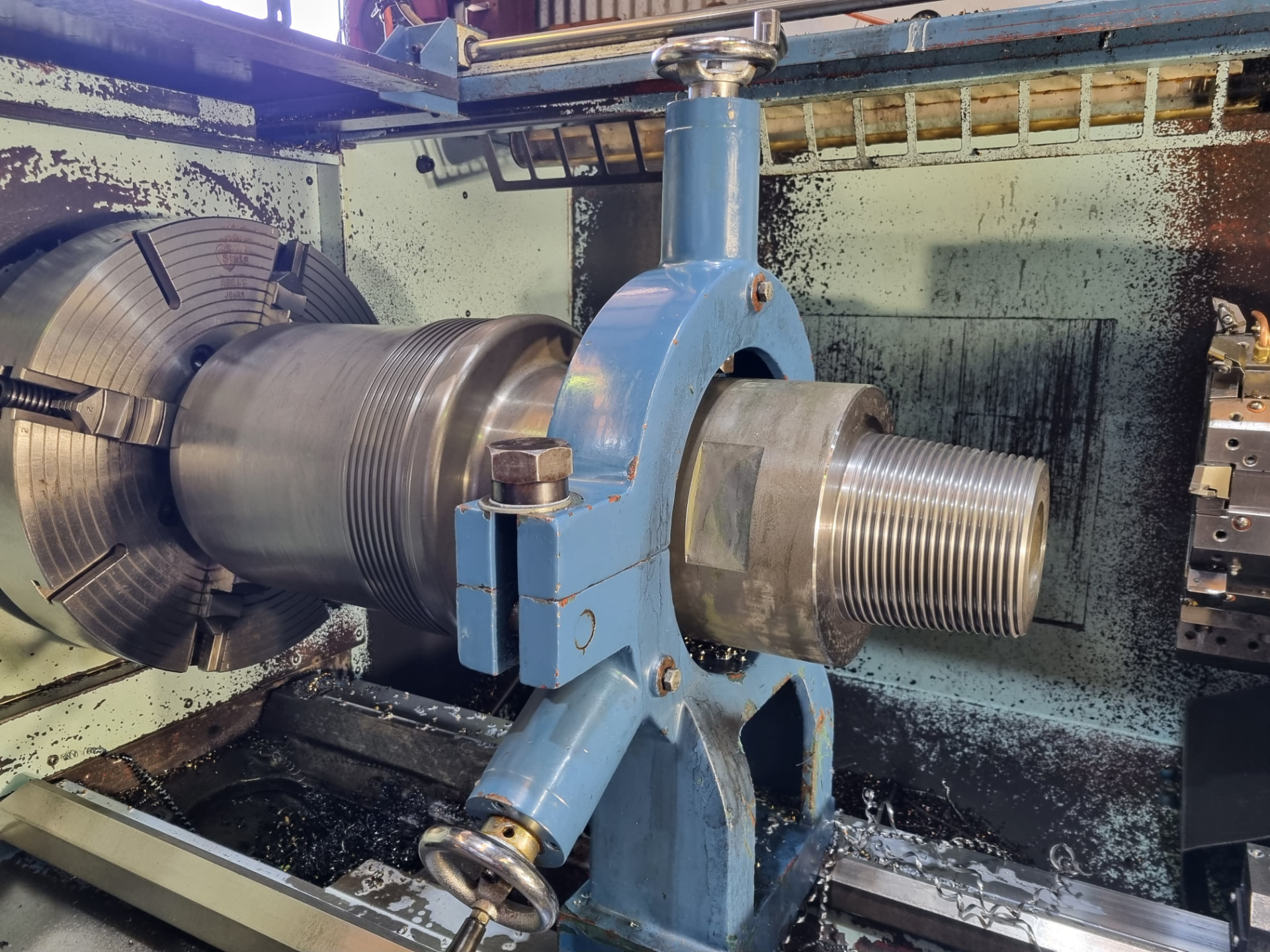 Threaded casing component being machined on a lathe