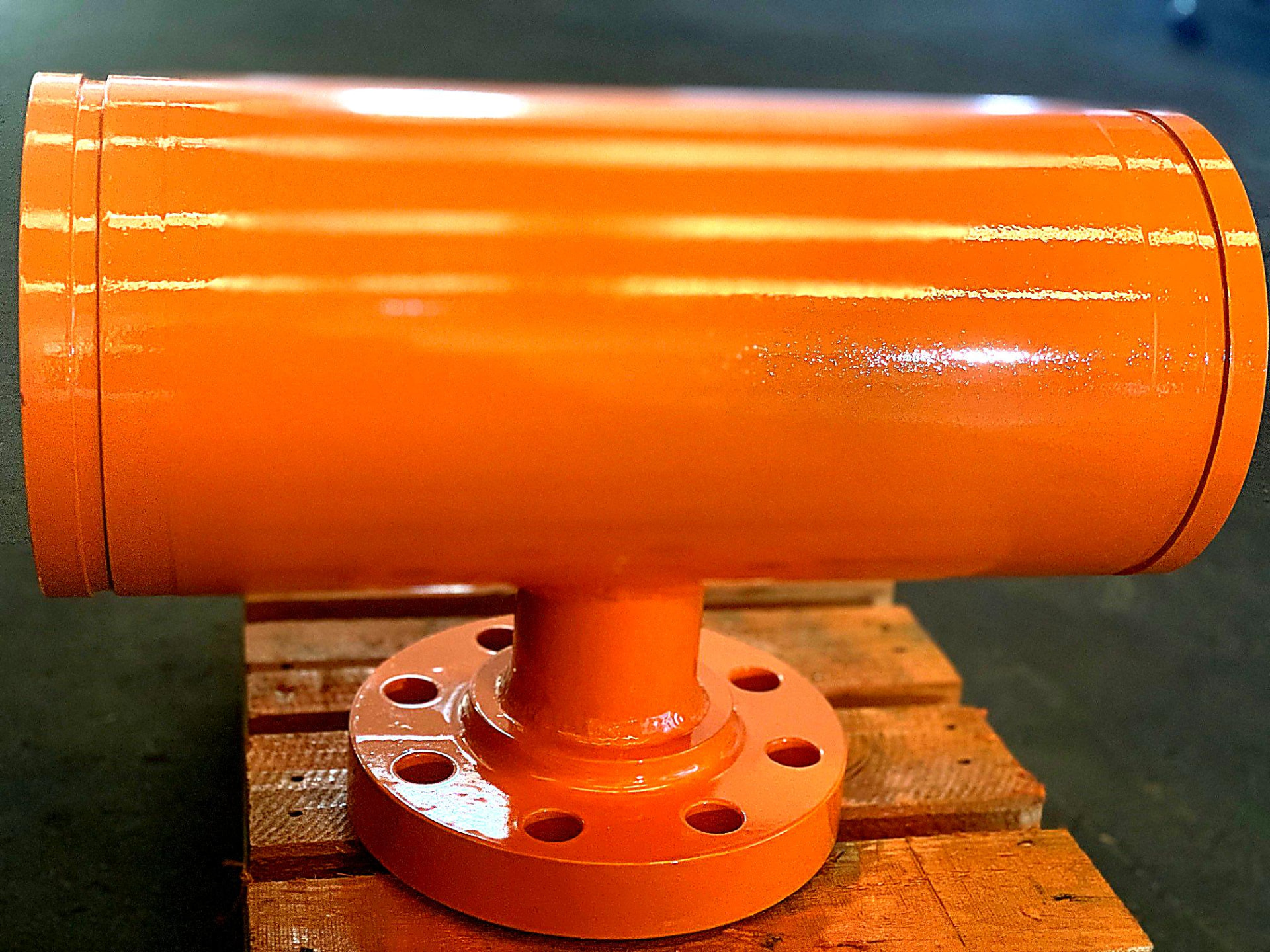 Orange flanged casing spool finished in the Allegiant workshop